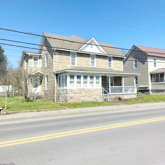 view of front of property with a porch and stone siding