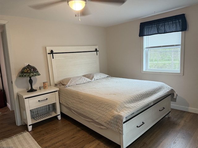 bedroom with dark wood-style floors, ceiling fan, and baseboards