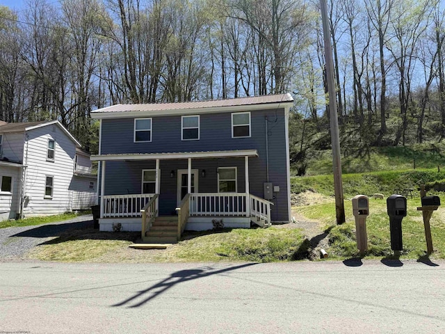 view of front of property with covered porch and metal roof