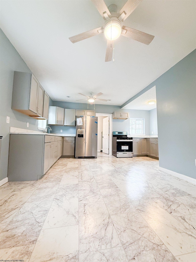 125 E Long St, Grafton, WV 26354 - kitchen with stainless steel appliances, gray cabinets, marble finish floor, a ceiling fan, and light countertops