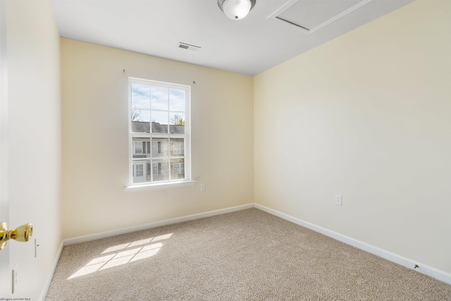 spare room featuring visible vents, carpet flooring, and baseboards