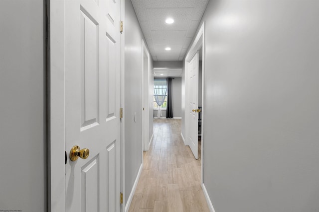 hallway with recessed lighting, light wood-style flooring, and baseboards