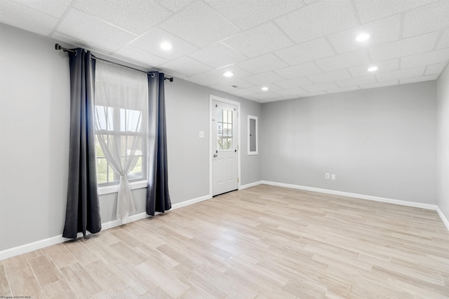unfurnished room featuring recessed lighting, light wood-style flooring, and baseboards