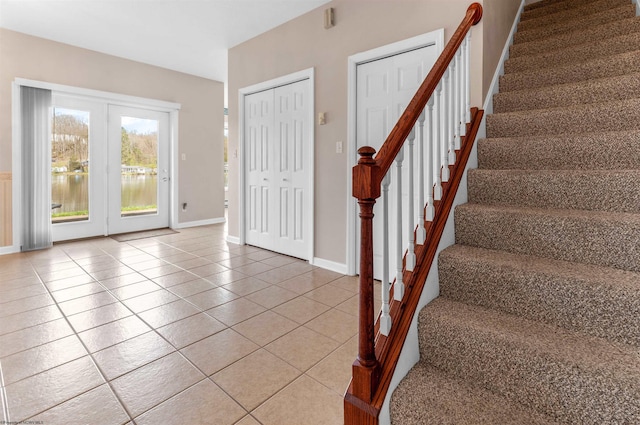 stairway featuring baseboards and tile patterned flooring