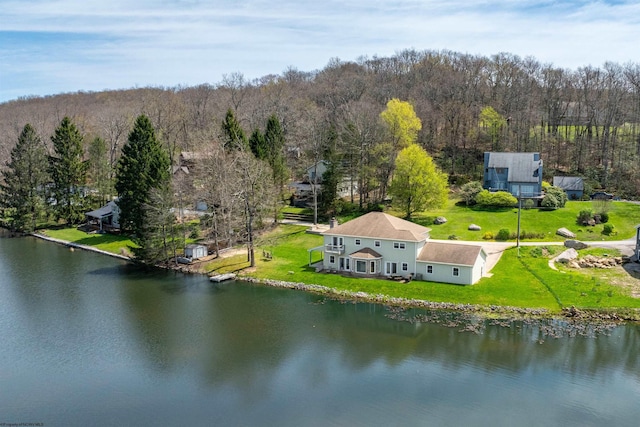 birds eye view of property with a water view and a forest view