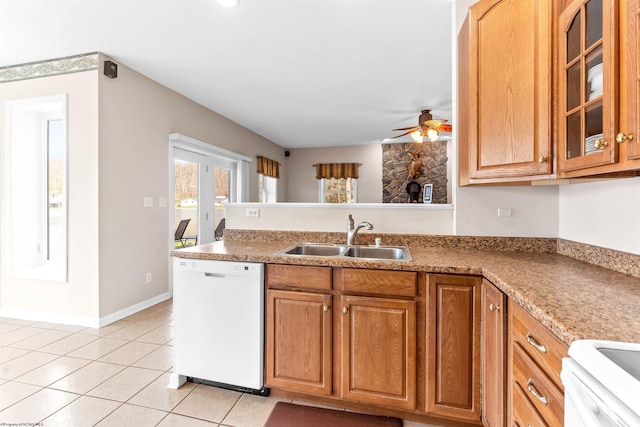 kitchen featuring light tile patterned floors, a sink, ceiling fan, white dishwasher, and a peninsula