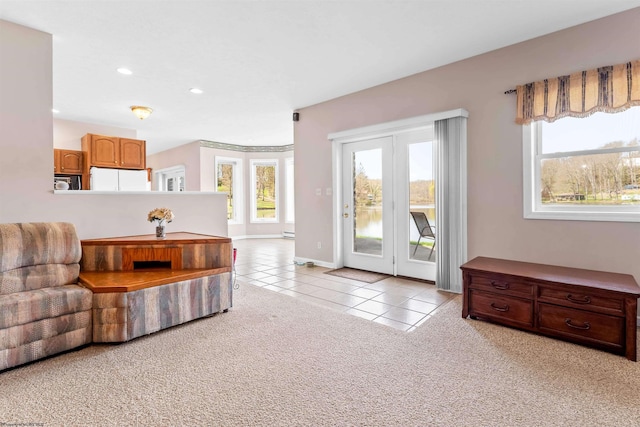 living room with light tile patterned floors, recessed lighting, baseboards, and a baseboard radiator