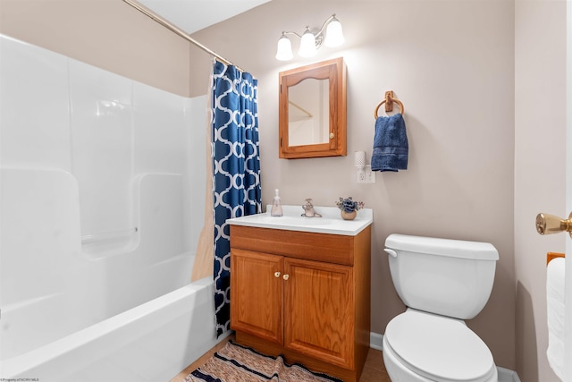 bathroom featuring shower / bath combination with curtain, toilet, and vanity