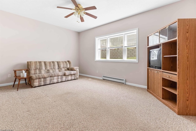 living area with light colored carpet, a ceiling fan, a baseboard heating unit, and baseboards
