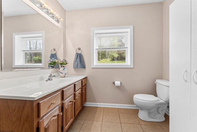 bathroom with tile patterned floors, vanity, toilet, and baseboards
