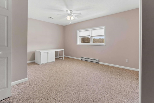 unfurnished bedroom featuring light colored carpet, a baseboard heating unit, ceiling fan, baseboards, and visible vents