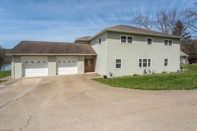 view of front of house with roof with shingles, a front yard, concrete driveway, and an attached garage