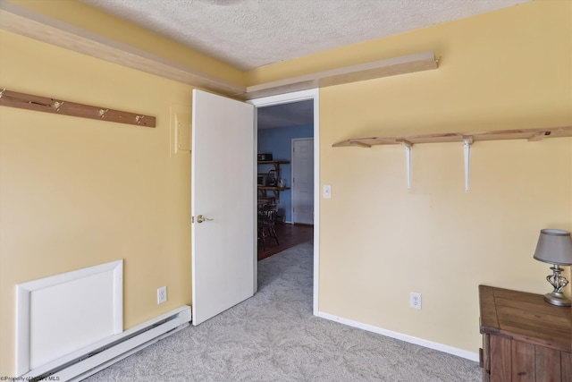 5570 Appalachian Hwy, Davis, WV 26260 - unfurnished bedroom featuring a textured ceiling, baseboard heating, light carpet, and baseboards