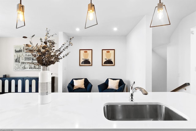 kitchen featuring hanging light fixtures, a sink, and light countertops
