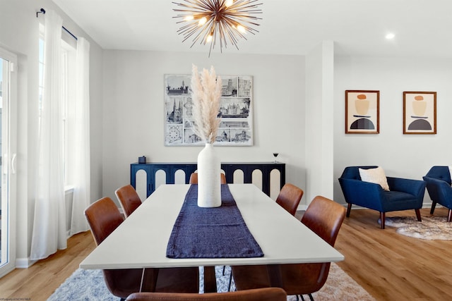 dining space with recessed lighting, an inviting chandelier, and light wood-type flooring