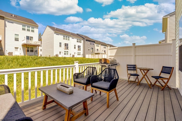 wooden deck featuring a residential view and a grill