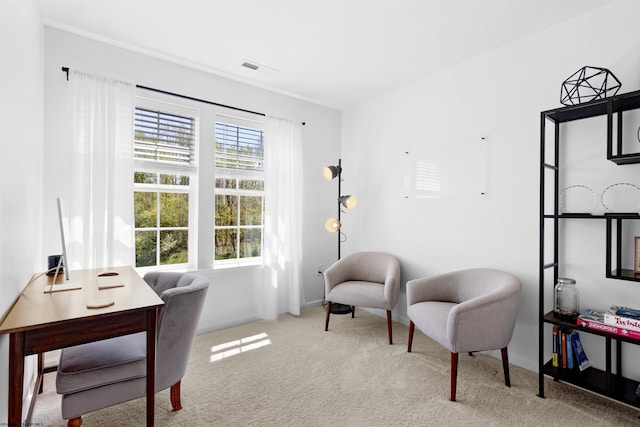 living area featuring baseboards, visible vents, and carpet floors