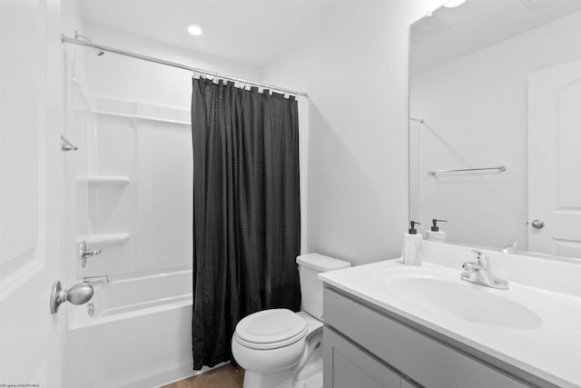 bathroom featuring shower / tub combo, vanity, toilet, and wood finished floors