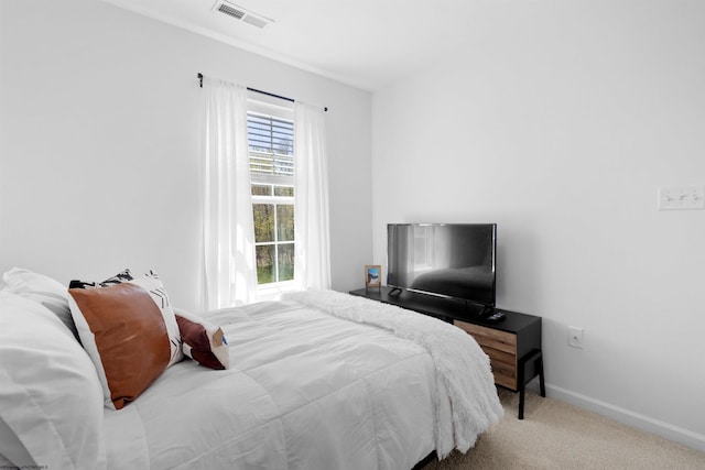 carpeted bedroom featuring baseboards and visible vents