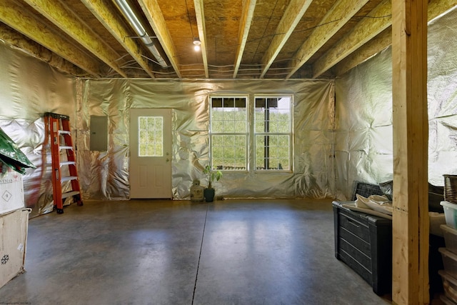 miscellaneous room featuring concrete floors and electric panel