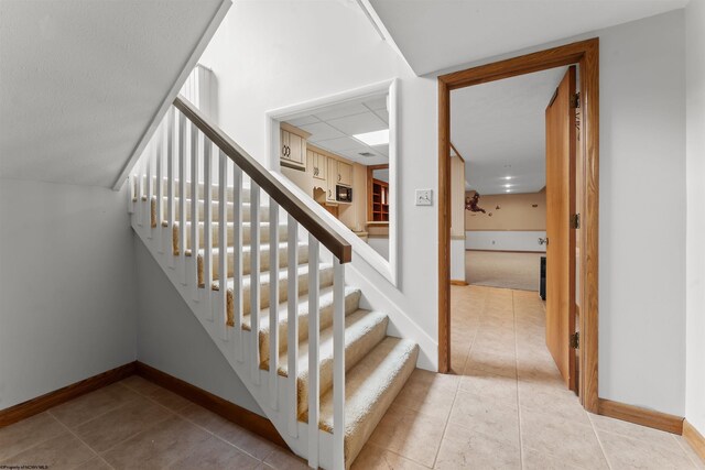 2254 Lakeside Ests, Morgantown, WV 26508 - staircase featuring baseboards and tile patterned flooring