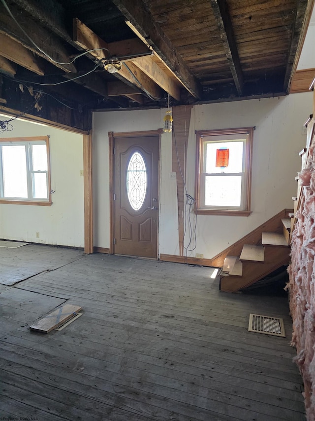 entryway featuring visible vents, stairs, and hardwood / wood-style floors