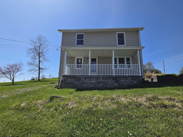 view of front of property with covered porch and a front lawn