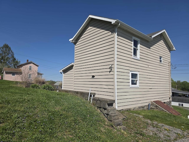 view of side of property with a lawn
