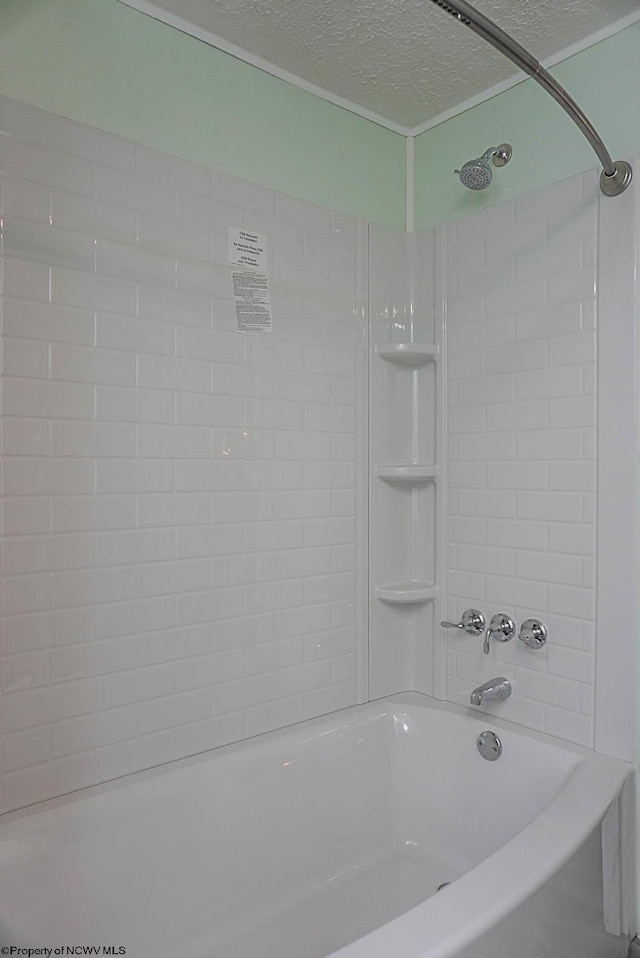 full bath featuring a textured ceiling and shower / bathing tub combination