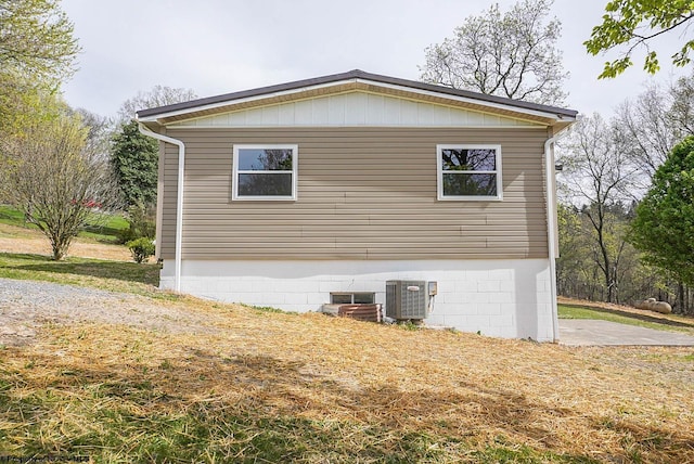 view of side of property featuring central air condition unit