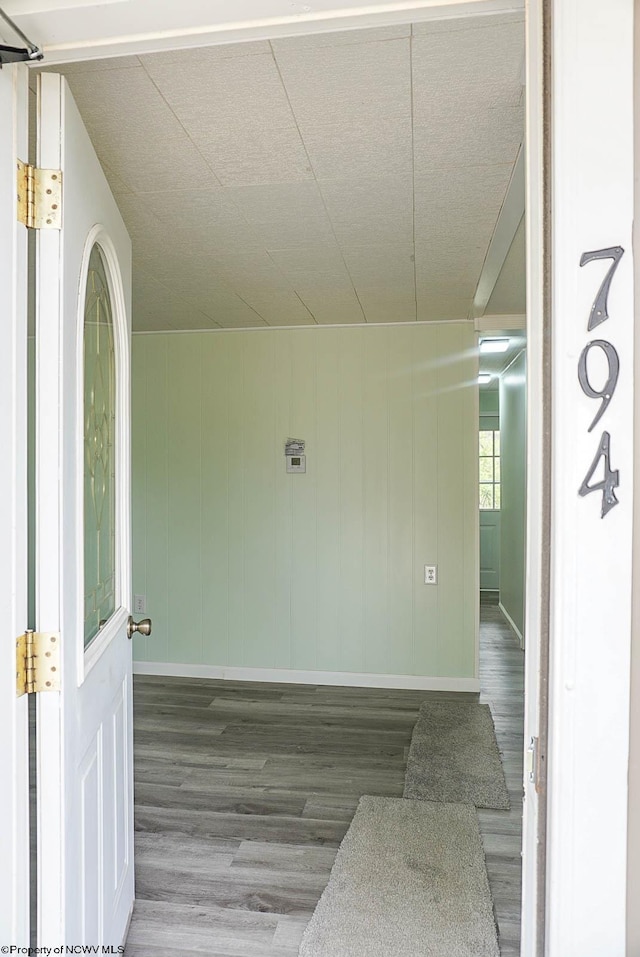 unfurnished room featuring baseboards and wood finished floors