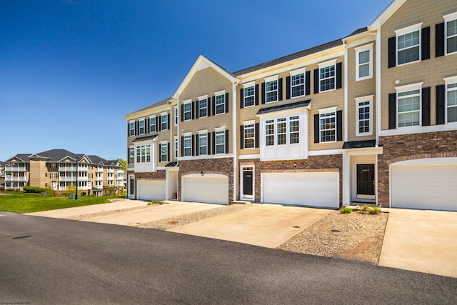 3005 Sun Vw, Morgantown, WV 26505 - townhome / multi-family property featuring a garage, driveway, and stone siding