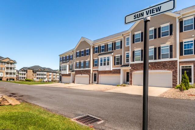 3005 Sun Vw, Morgantown, WV 26505 - view of property featuring an attached garage, driveway, a residential view, and stone siding