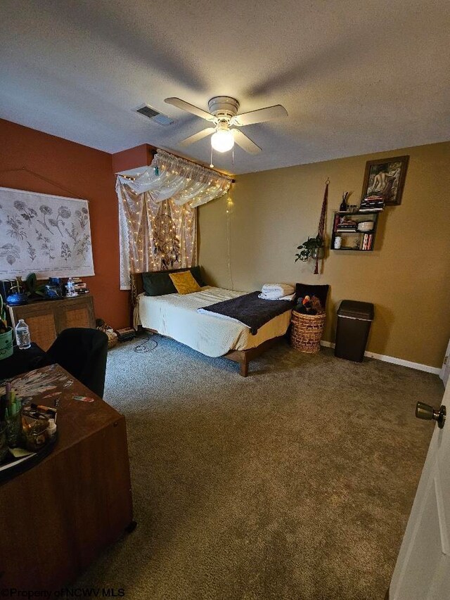 carpeted bedroom with visible vents, a ceiling fan, a textured ceiling, and baseboards