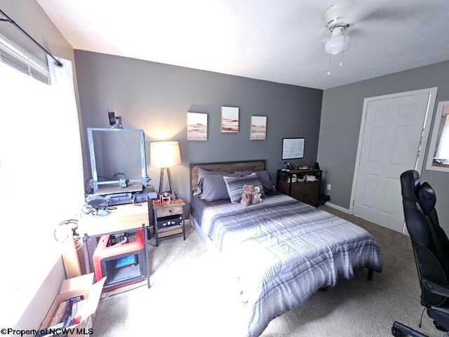 bedroom featuring multiple windows, carpet, and ceiling fan