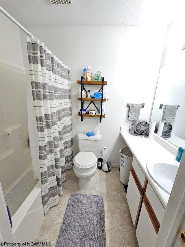 bathroom featuring vanity, toilet, tile patterned floors, baseboards, and visible vents