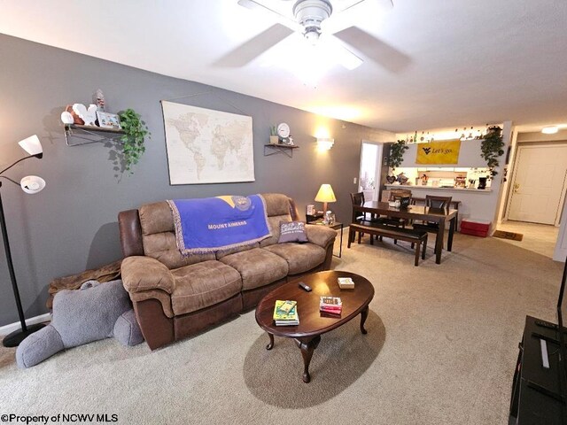 carpeted living room featuring a ceiling fan