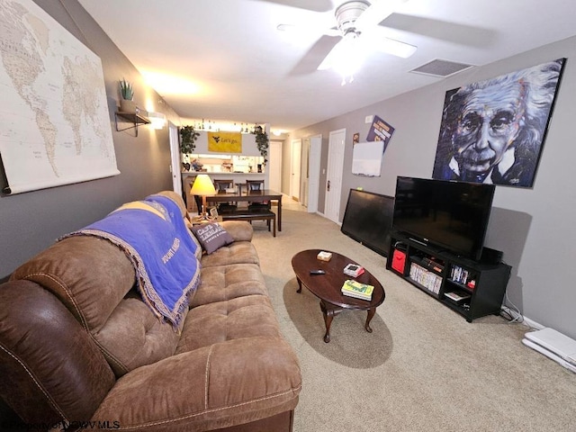 carpeted living room with visible vents and ceiling fan