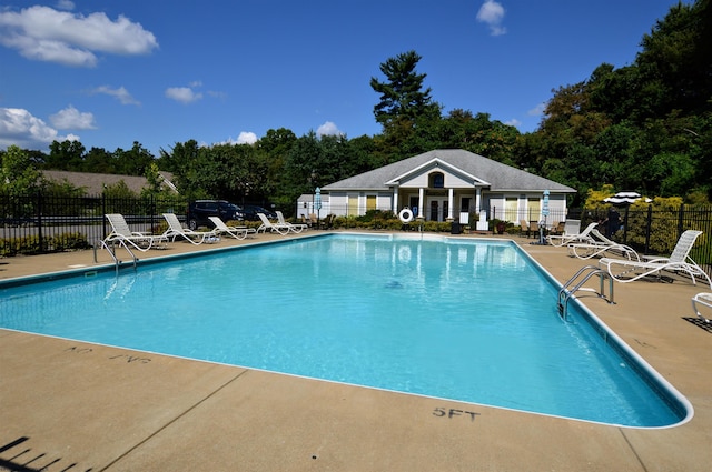 pool featuring a patio area and fence