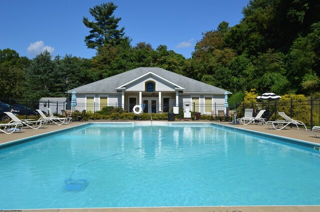 pool featuring a patio area and fence