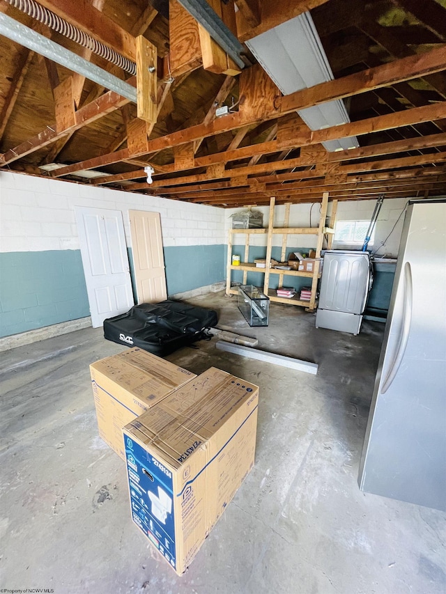 520 Mount Vernon Ave, Fairmont, WV 26554 - garage with concrete block wall, freestanding refrigerator, and washer / clothes dryer