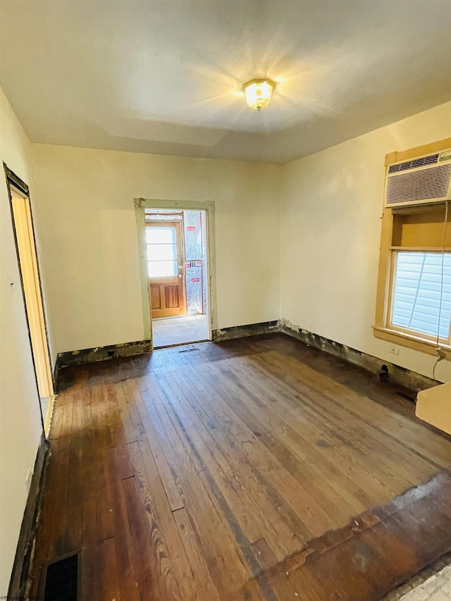 520 Mount Vernon Ave, Fairmont, WV 26554 - empty room featuring an AC wall unit, visible vents, a wealth of natural light, and hardwood / wood-style flooring