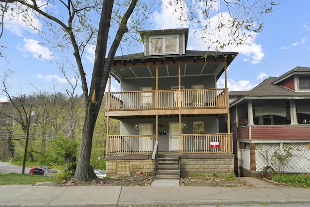 view of front of home with a porch and a balcony