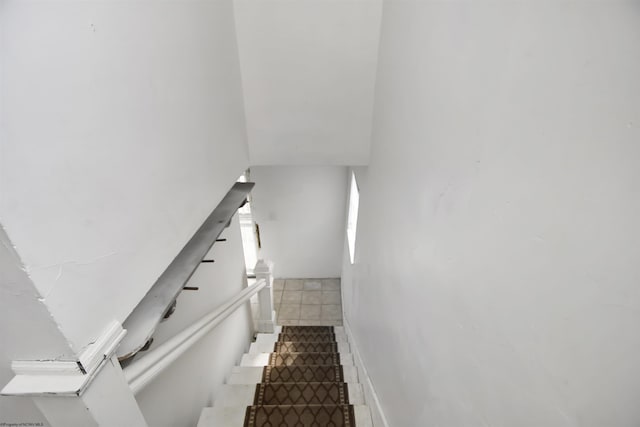 staircase featuring tile patterned floors