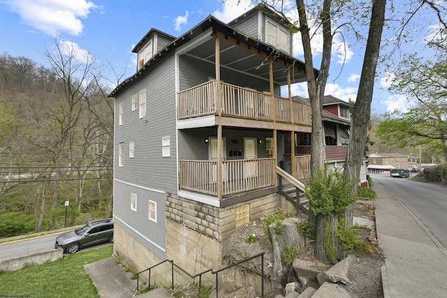 rear view of property featuring a balcony