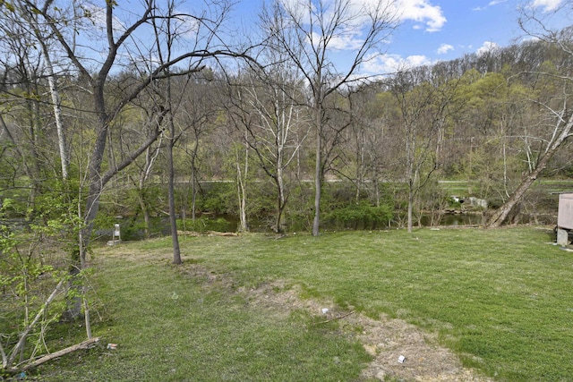 view of yard with a forest view