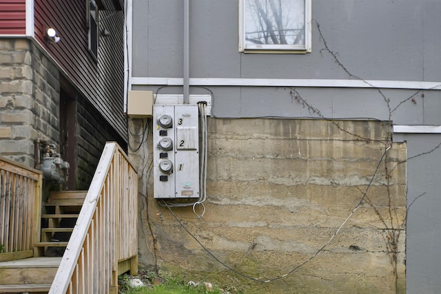 exterior details with stairway, gas meter, and electric meter