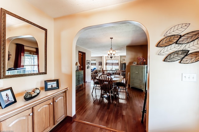 1252 Monumental Rd, Fairmont, WV 26554 - dining area with dark wood-type flooring, arched walkways, baseboards, and an inviting chandelier