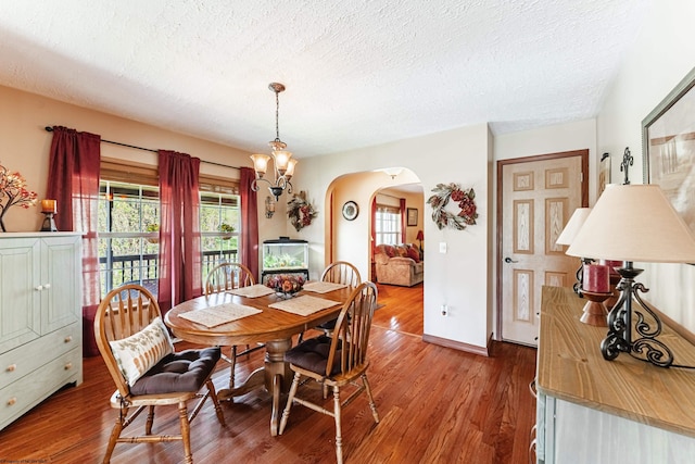 1252 Monumental Rd, Fairmont, WV 26554 - dining room featuring baseboards, arched walkways, a textured ceiling, and wood finished floors