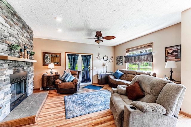 1252 Monumental Rd, Fairmont, WV 26554 - living room with a ceiling fan, a textured ceiling, wood finished floors, and a fireplace